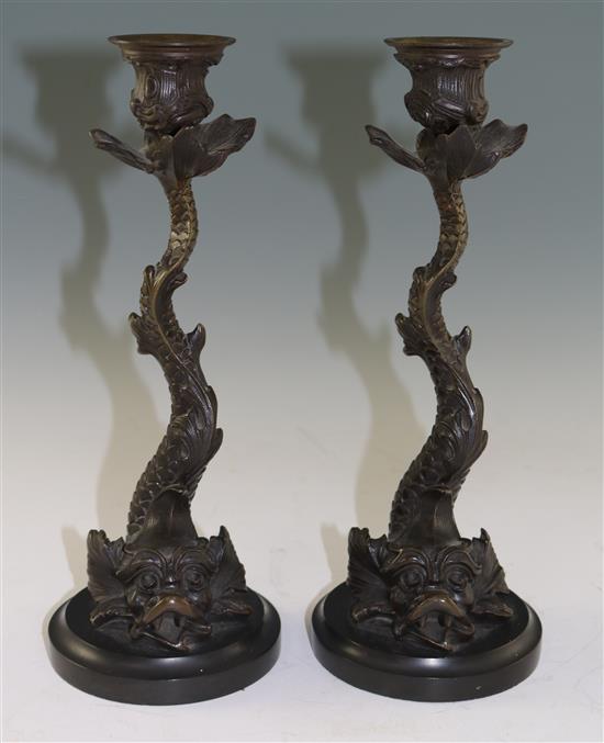 A pair of 19th century bronze candlesticks, modelled as dolphins, 10.5in.